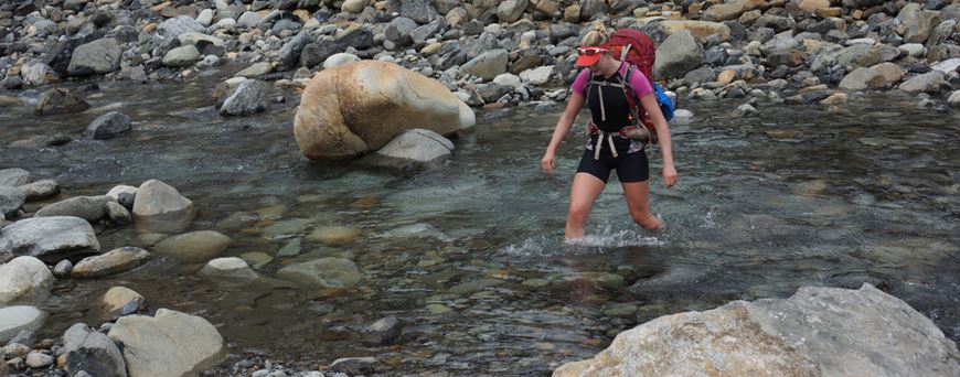 Anna McNuff crossing a river in the Redhills on the Te Araroa Trail